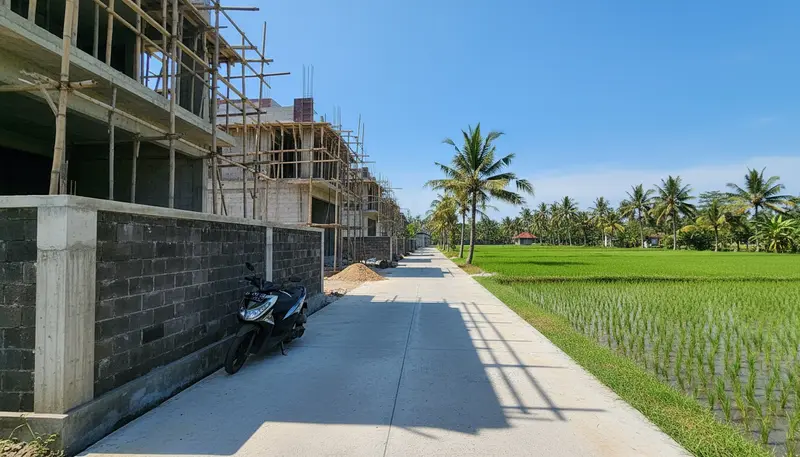 Modern rental villas under construction next to rice fields in Canggu, Bali